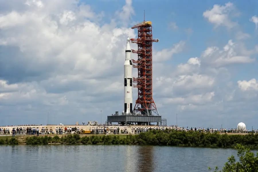 Illustrated Apollo 11 launch-pad scene with a Saturn V rocket