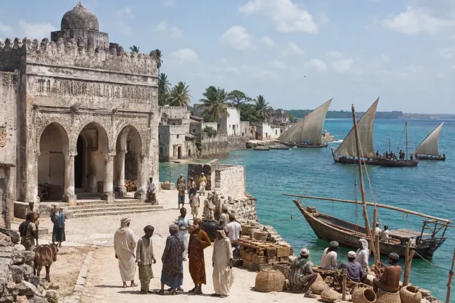 Illustrated historical harbor at Kilwa with sailing vessels and stone buildings